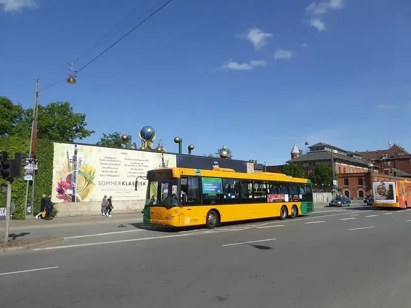 yellow and green city bus parked on Bernstorffsgade street in Copenhagen